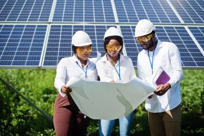 african american technician checks maintenance solar panels group three black engineers meeting solar station scaled e1772461154598